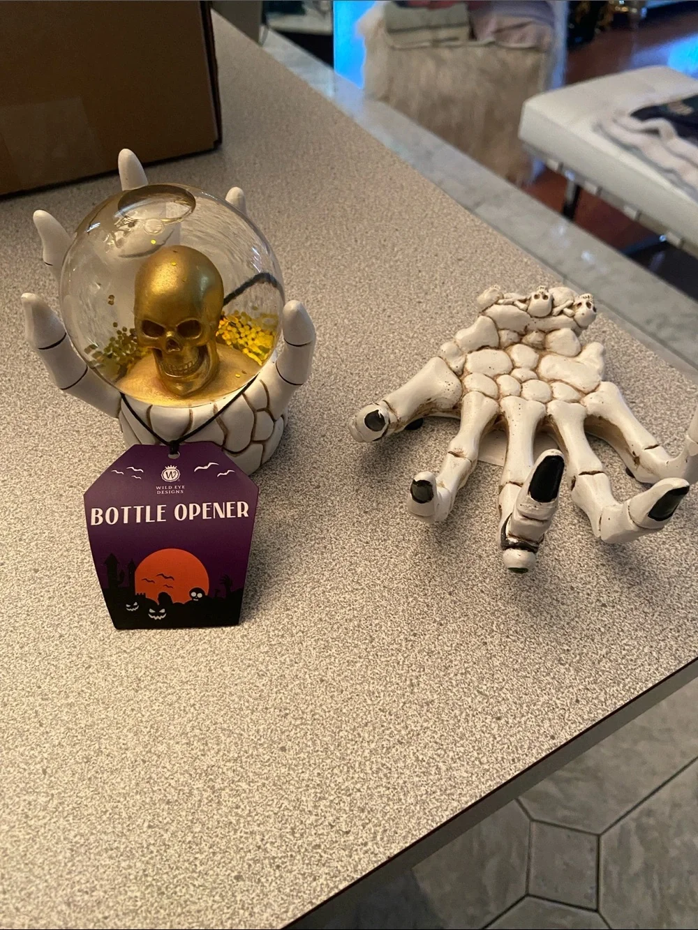Williams Sonoma Gold Skull Snow Globe and White Skeleton Hand Bottle Opener